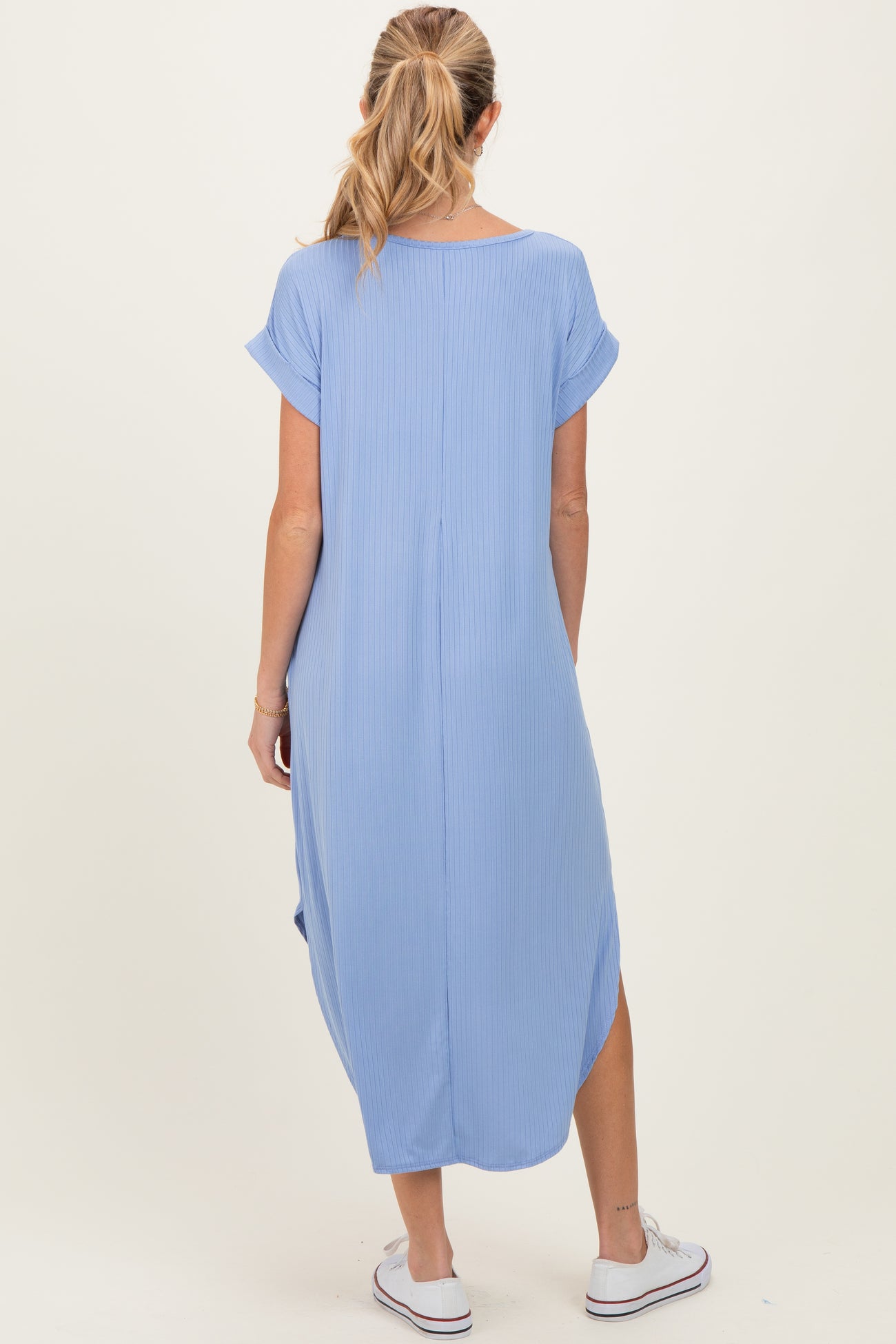 woman wearing a light blue maternity maxi dress with short sleeves and a relaxed fit, showing the back view