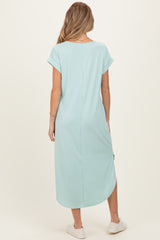 woman wearing a mint green maternity maxi dress with short sleeves and side slits, showing her back