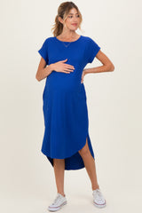 woman wearing a royal blue ribbed maternity dress with short sleeves and side slits, highlighting her baby bump