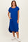 woman wearing a blue ribbed short sleeve midi dress with side pockets and a curved hemline