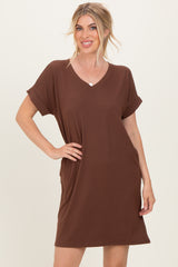 woman wearing a brown short sleeve v-neck dress with a relaxed fit