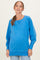 woman wearing a blue long sleeve maternity sweatshirt with a relaxed fit and a baby bump visible