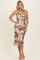 woman wearing a brown floral midi dress with spaghetti straps and a fitted silhouette
