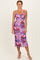 woman wearing a purple floral midi dress with slim straps and a fitted silhouette