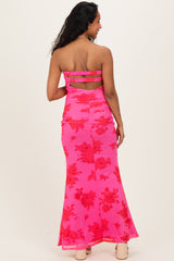 woman wearing a pink floral maternity maxi dress with a ruched design and strapless neckline