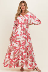 woman wearing a floral printed maternity maxi dress with a v-neck and cinched waist
