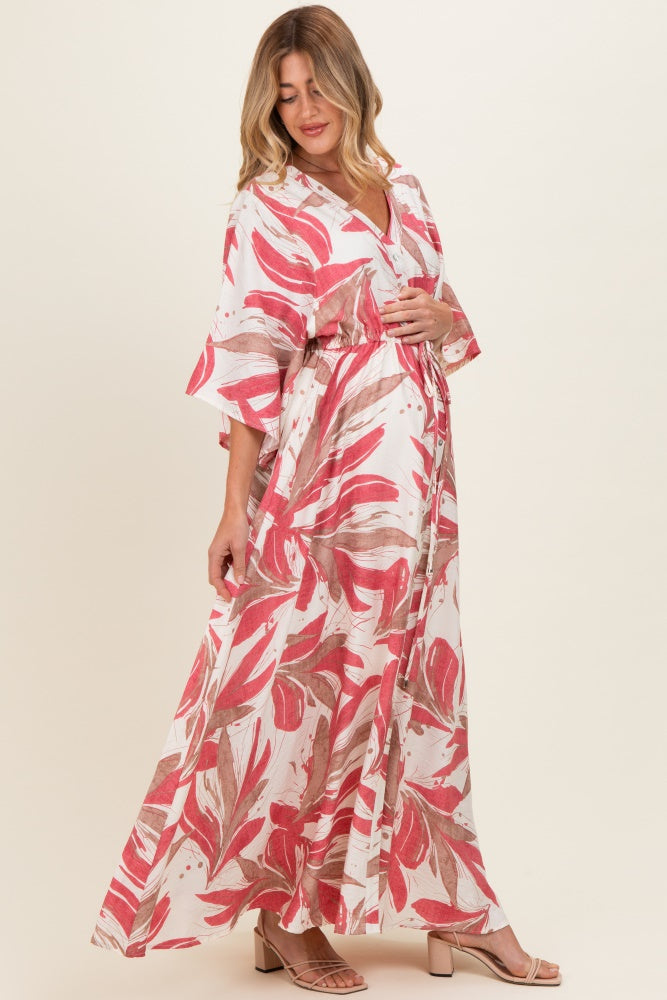 woman wearing a floral print maternity maxi dress with bell sleeves and a visible baby bump