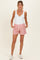 woman wearing a white maternity tank top and red striped shorts with pockets