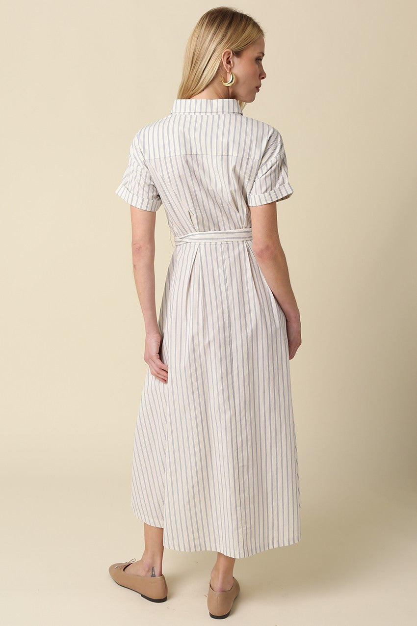 woman wearing a striped midi shirt dress with short sleeves and a tie belt, shown from the back