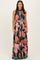 woman wearing a black floral maxi dress with pink flowers and a tie waist detail