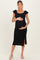 woman wearing a black ruffled maternity dress with a side slit and holding her baby bump