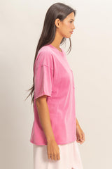 woman wearing a pink oversized t-shirt with a chest pocket and short sleeves