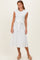 woman wearing a white cap sleeve midi dress with a tie waist and textured floral pattern, posing with a neutral backdrop