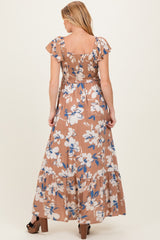 woman wearing a brown floral print maternity maxi dress with ruffle sleeves, showing the back view