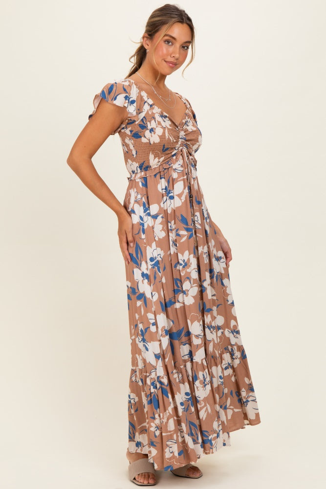 woman wearing a brown floral maxi dress with short sleeves and a ruched bodice