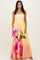 woman wearing a strapless yellow maxi dress with pink floral pattern