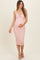 woman wearing a light pink ribbed maternity dress with a knot detail, gently holding her baby bump