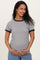 woman wearing a navy and white striped maternity top and holding her baby bump