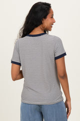 woman wearing a navy and white striped maternity t-shirt with contrast sleeves, showing a relaxed fit from the back