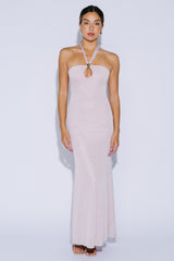woman wearing a blush pink halter neck gown with a keyhole detail and a fitted silhouette