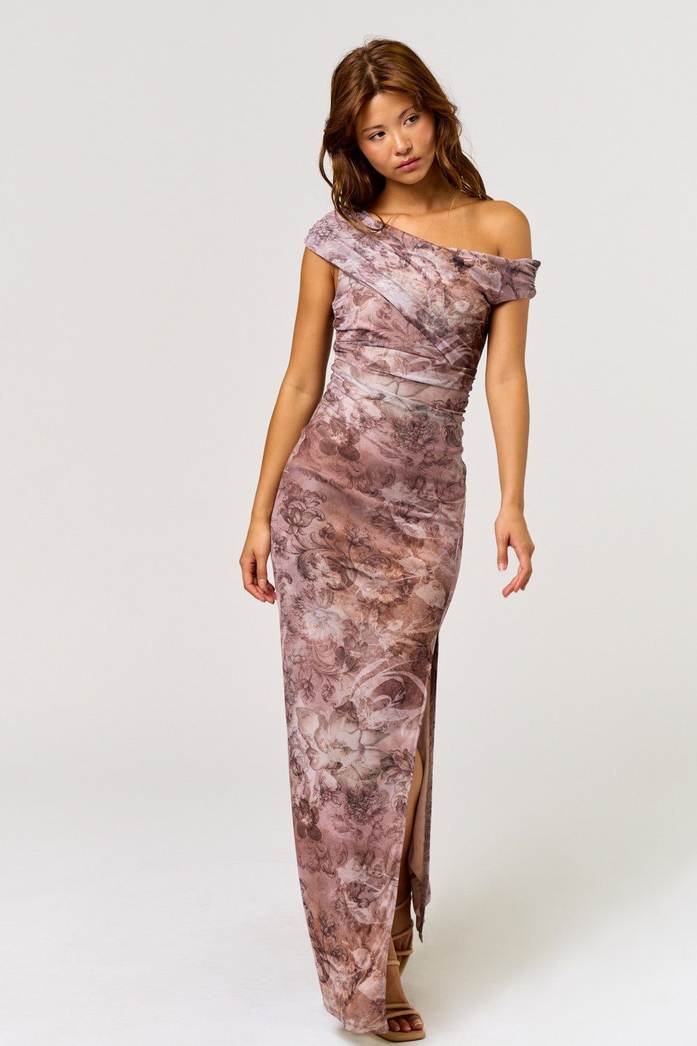 woman wearing a floral off-the-shoulder maxi dress with a thigh-high slit and ruched details
