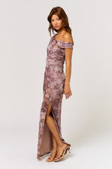 woman wearing a off-the-shoulder floral print evening gown with a high slit and strappy heels
