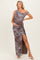 woman wearing a floral off-shoulder maternity dress with a side slit, showcasing her baby bump