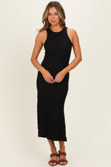 woman wearing a black ribbed knit sleeveless midi dress with side slits and a fitted silhouette