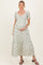 woman wearing a floral printed maternity maxi dress with puff sleeves and holding her baby bump