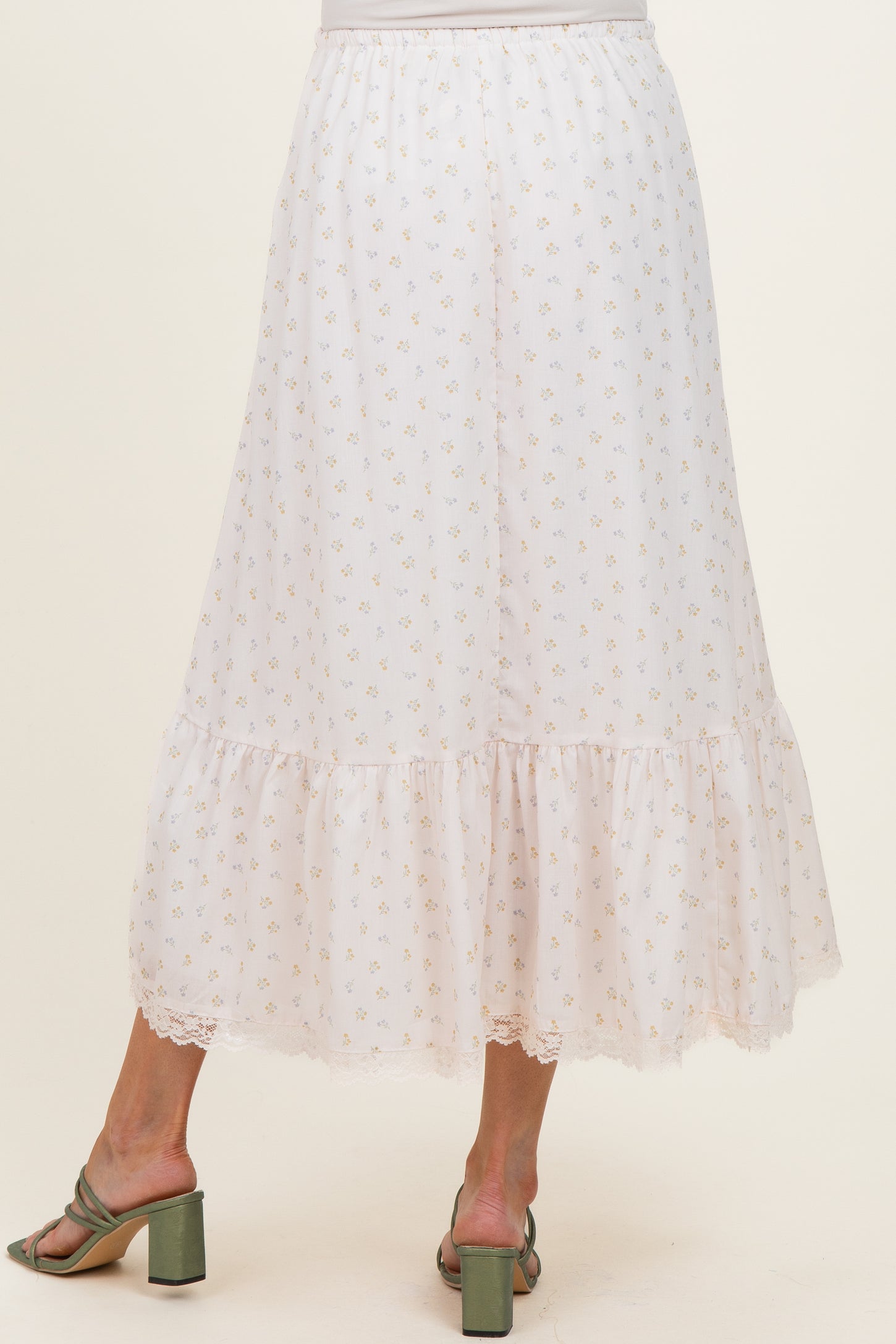 maternity wear white floral maxi skirt with lace trim and an elastic waistband, model wearing it from behind
