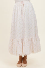 woman wearing a light pink printed midi skirt with ruffle hem and drawstring waist