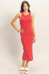 woman wearing a red tank dress with a fitted silhouette and side slits, standing in white slide sandals