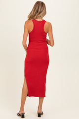 woman wearing a red ribbed maternity midi dress with a side slit and racerback style, shown from the back