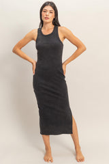 woman wearing a black sleeveless midi dress with a side slit
