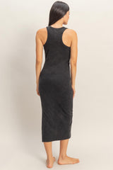 woman wearing a black ribbed midi tank dress, showing the back view and styled with a fitted silhouette