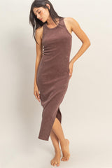 woman wearing a brown ribbed midi dress with a side slit and sleeveless design