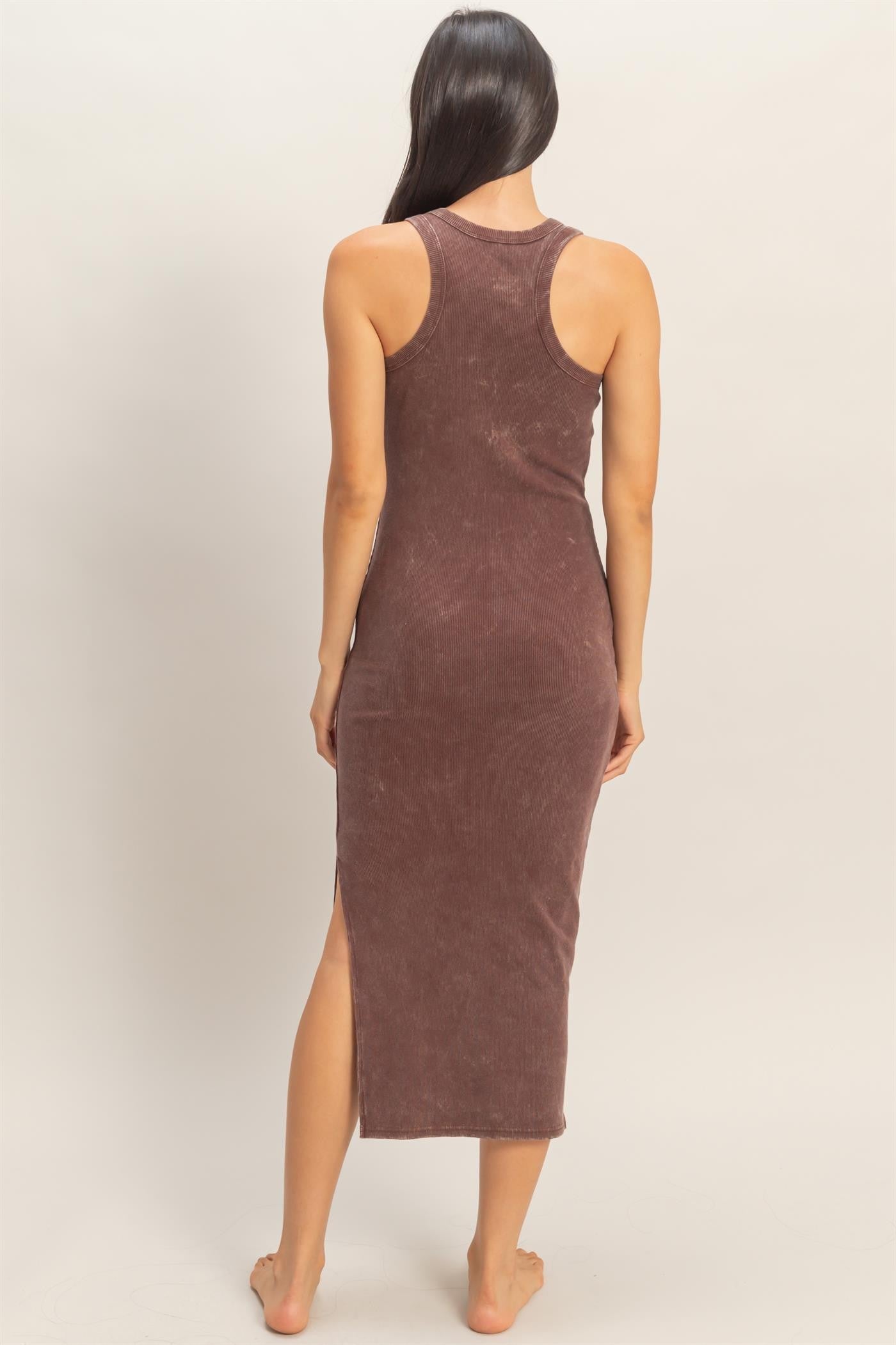woman wearing a brown ribbed midi dress with side slits and a racerback style
