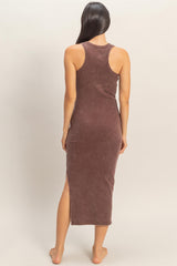 woman wearing a brown ribbed midi dress with side slits and a racerback style