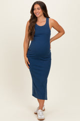 woman wearing a navy blue ribbed maternity maxi dress with a fitted silhouette and visible baby bump