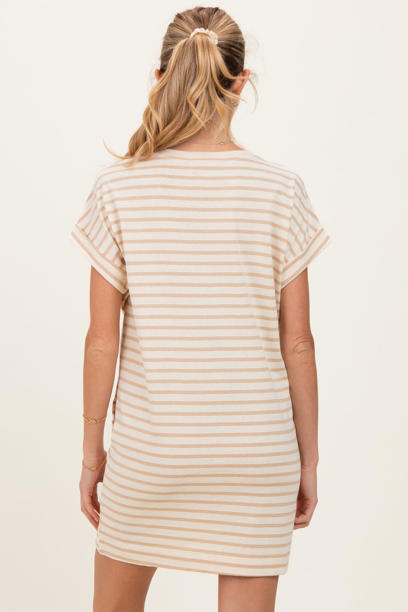woman wearing a striped maternity dress with short sleeves, showing the back view