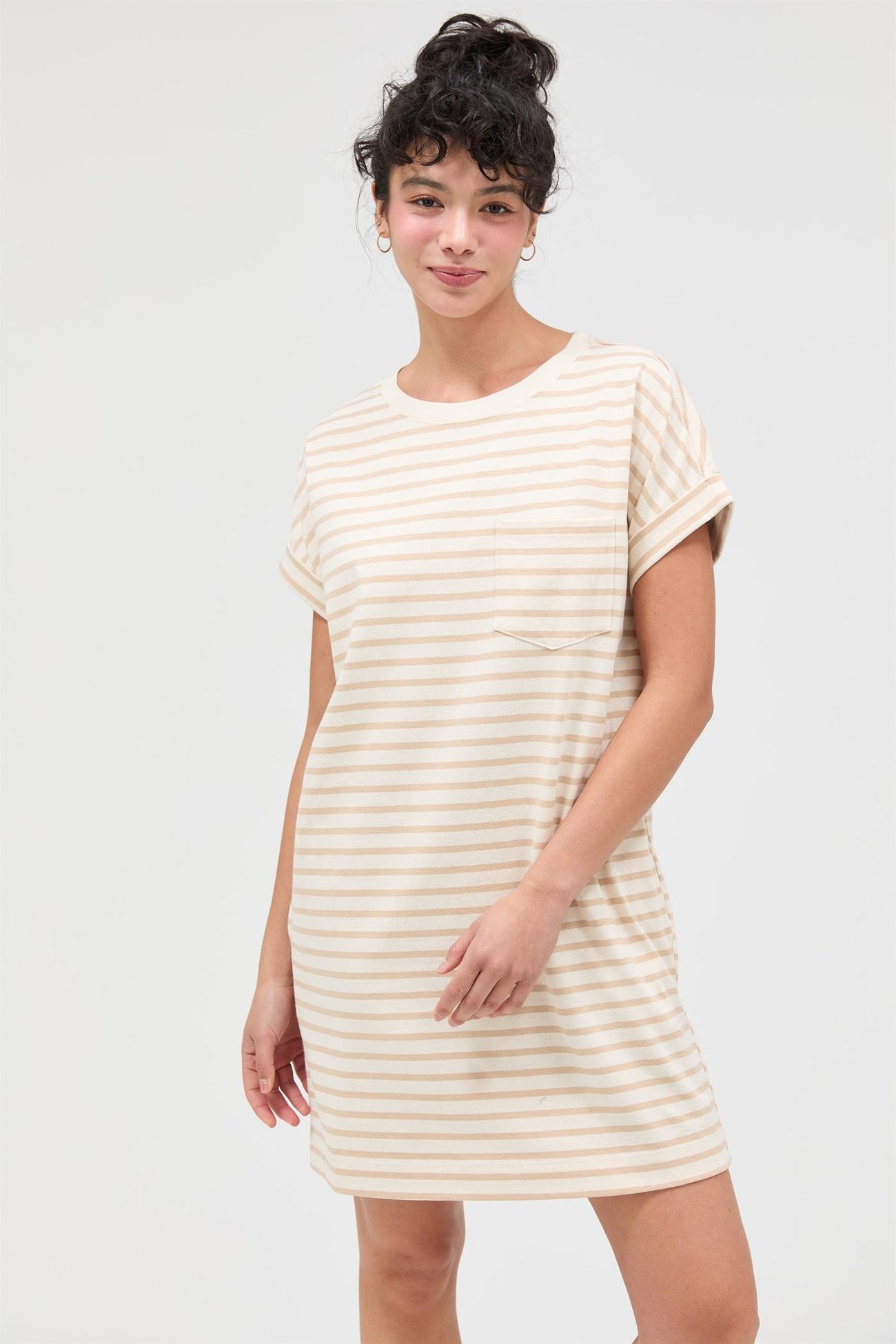 woman wearing a cream and beige striped t-shirt dress with a pocket and rolled sleeves