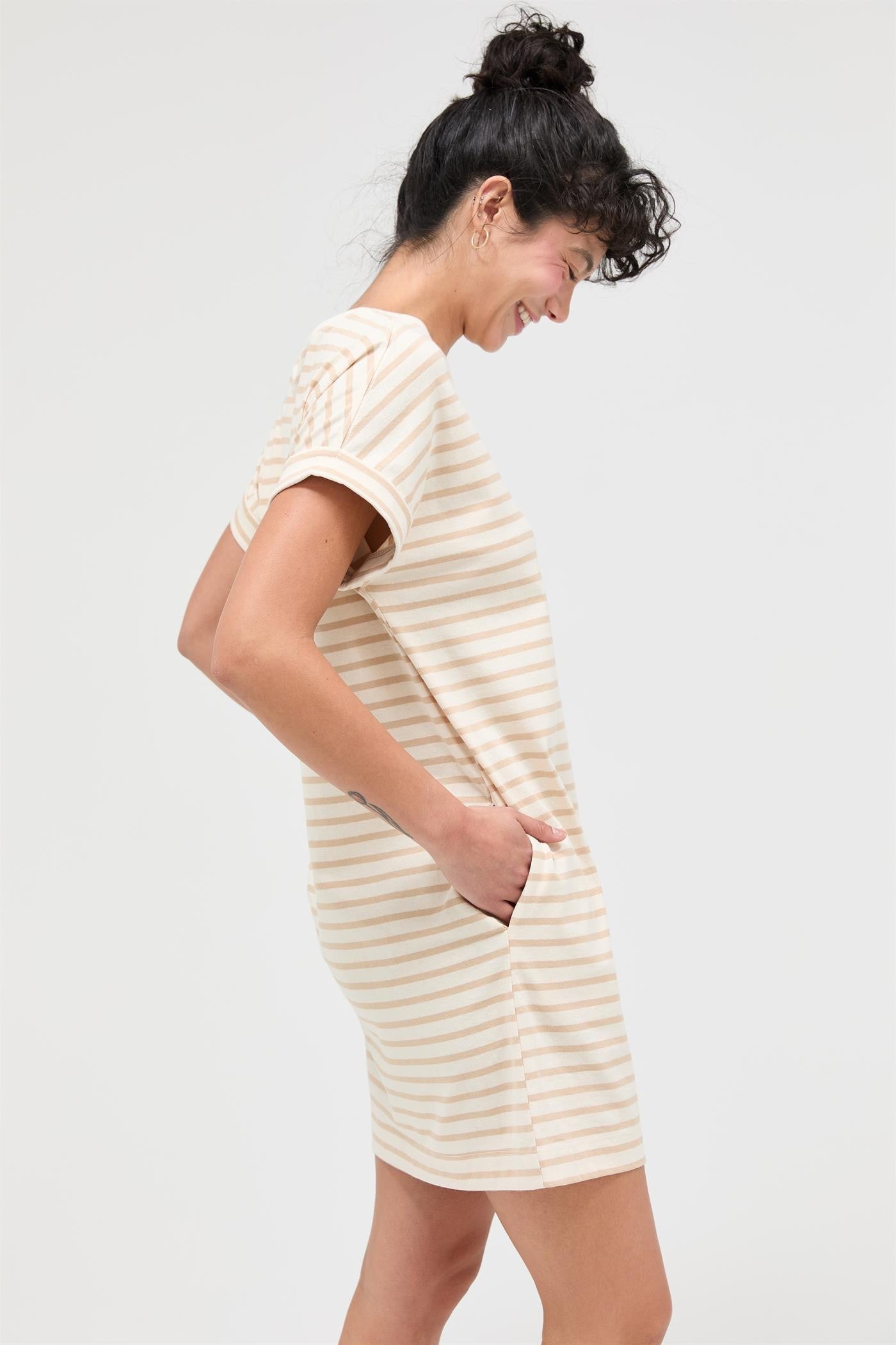 woman wearing a beige and white striped t-shirt dress with short sleeves and side pockets