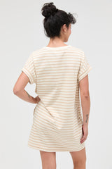 woman wearing a striped short sleeve shift dress with rolled cuffs, shown from the back