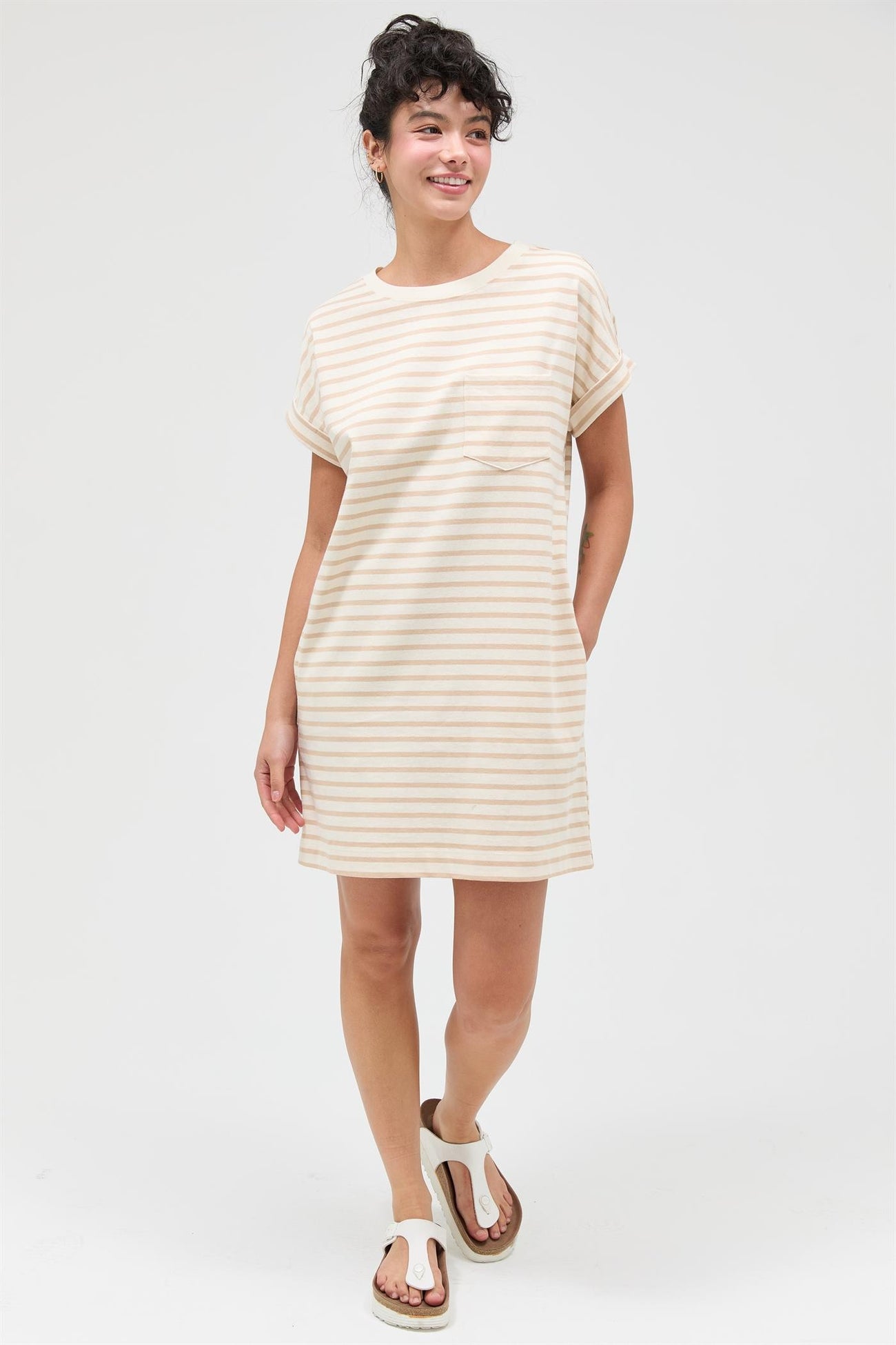 woman wearing a short sleeve cream and beige striped casual dress with a pocket and relaxed fit