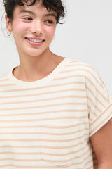 woman wearing a beige and cream striped short sleeve t-shirt with a chest pocket and smiling