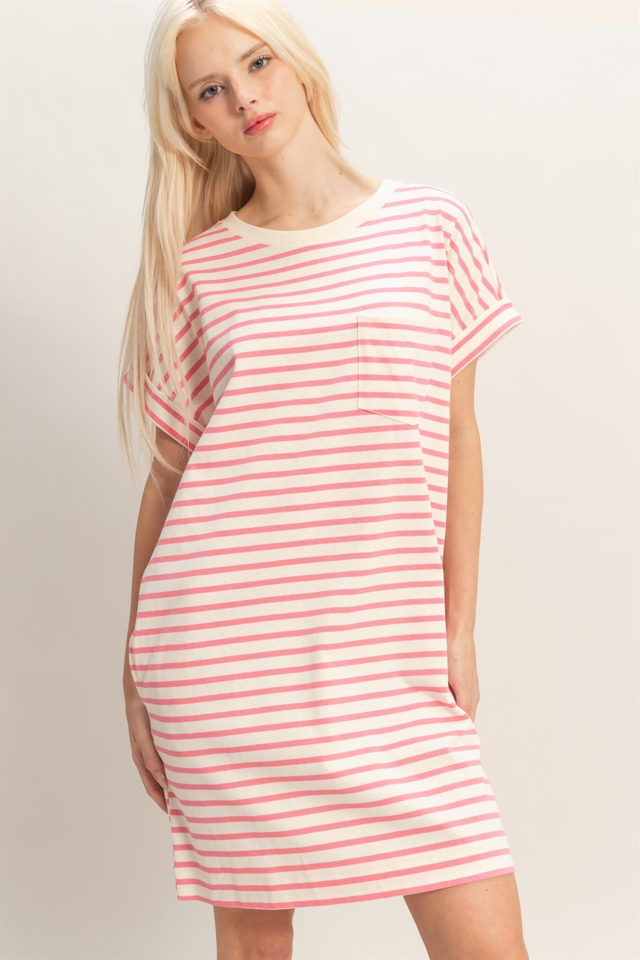 woman wearing a pink and white striped short sleeve dress with a pocket
