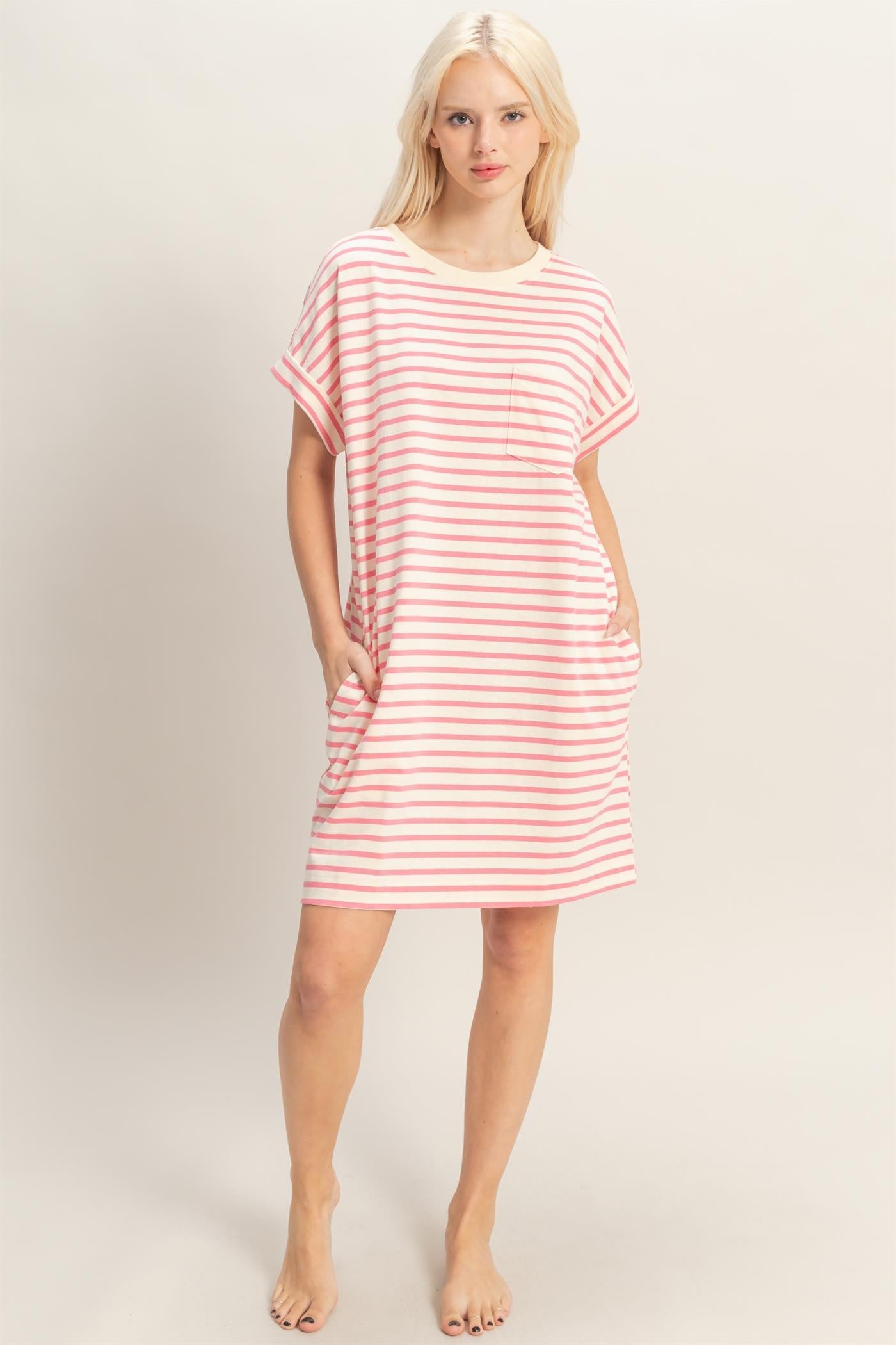 woman wearing a pink and white striped short sleeve dress with pockets and a relaxed fit