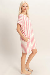 woman wearing a pink and white striped short sleeve dress with pockets