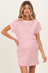 woman wearing a pink and white striped maternity dress with short sleeves and a pocket