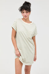 woman wearing a cream and green striped oversized t-shirt dress with rolled sleeves